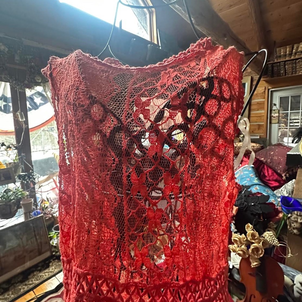 Beautful orange lace dress which has zipper in back and will need an underslip .